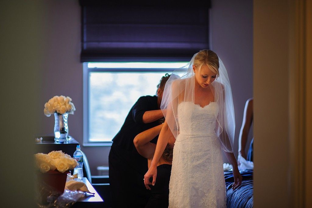 bride getting dressed - photo by Iowa City wedding photographer razvan