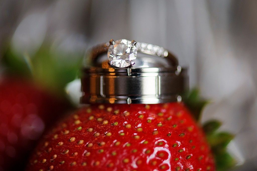 closeup of a wedding ring on strawberry